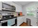 Bright kitchen with stainless steel oven and microwave, white cabinets, and granite countertops at 4252 Sheldon Pl # 4252, New Port Richey, FL 34652