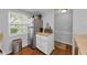 Bright kitchen featuring stainless steel refrigerator, granite countertops, white cabinetry, and hardwood flooring at 4252 Sheldon Pl # 4252, New Port Richey, FL 34652