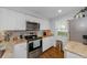 Well-lit kitchen with stainless steel appliances, granite countertops, white cabinets, and hardwood flooring at 4252 Sheldon Pl # 4252, New Port Richey, FL 34652