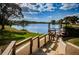 Scenic lake view featuring a well-maintained lawn and a wooden dock at 4252 Sheldon Pl # 0, New Port Richey, FL 34652