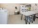 Well-equipped laundry room featuring multiple washers, dryers, and folding station at 4252 Sheldon Pl # 4252, New Port Richey, FL 34652