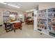 Cozy library space with bookshelves, tables, and chairs, ideal for reading and quiet study at 4252 Sheldon Pl # 4252, New Port Richey, FL 34652