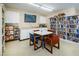 Well-lit library featuring shelves filled with books, a TV, and tables for quiet reading and study at 4252 Sheldon Pl # 4252, New Port Richey, FL 34652