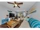 The beautiful living room offers wood floors, a ceiling fan, and a view to the backyard at 4252 Sheldon Pl # 4252, New Port Richey, FL 34652
