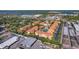 Aerial view of a multi-building residential complex featuring a pool, tennis court, and ample parking spaces at 10764 70Th Ave # 1205, Seminole, FL 33772