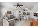Open-concept living room and kitchen features tile floors, ceiling fan, eat-in bar, and comfortable seating at 10764 70Th Ave # 1205, Seminole, FL 33772
