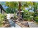 Relaxing backyard features mature palm trees, lush gardens, and peaceful privacy at 12116 N 52Nd St, Temple Terrace, FL 33617