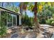 Charming backyard featuring lush tropical landscaping and decorative stone walkway at 12116 N 52Nd St, Temple Terrace, FL 33617