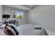 Bedroom featuring sleek desk, lush pillows, and bright window with mature trees at 12116 N 52Nd St, Temple Terrace, FL 33617