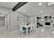 Bright dining area with white table, blue accents, and easy access to the open floor plan at 12116 N 52Nd St, Temple Terrace, FL 33617