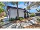 Single-story home with a charming walkway, surrounded by garden at 12116 N 52Nd St, Temple Terrace, FL 33617