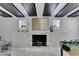 Close-up of the fireplace with black interior and decorative mantel, set against a wall with ceiling beams at 12116 N 52Nd St, Temple Terrace, FL 33617