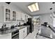Kitchen view with stainless steel appliances, black granite countertop, and skylight at 12116 N 52Nd St, Temple Terrace, FL 33617