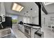 Open kitchen view with stainless steel oven, bar top, and skylight at 12116 N 52Nd St, Temple Terrace, FL 33617