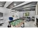 Bright living space with a foosball table, fireplace, and open access to the dining area at 12116 N 52Nd St, Temple Terrace, FL 33617