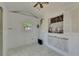 Light, bright living space with shiplap walls and white marble floors. Window with shutters at 12116 N 52Nd St, Temple Terrace, FL 33617