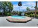 A gorgeous swimming pool surrounded by a deck and a concrete patio with lush landscaping at 12116 N 52Nd St, Temple Terrace, FL 33617
