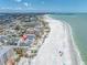 Aerial view of beachfront property with pristine sandy beach and sparkling ocean at 12274 1St W St # 2, Treasure Island, FL 33706