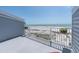 Balcony overlooking a beach with white railing and potted plants, offering a serene ocean view at 12274 1St W St # 2, Treasure Island, FL 33706