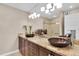 Bathroom featuring granite counters with vessel sinks, dark wood cabinetry, and modern lighting at 12274 1St W St # 2, Treasure Island, FL 33706
