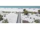 Picturesque boardwalk leading to a beautiful sandy beach with palm trees at 12274 1St W St # 2, Treasure Island, FL 33706