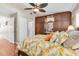 Bedroom featuring custom cabinetry, a ceiling fan, and a bright floral bedding at 12274 1St W St # 2, Treasure Island, FL 33706