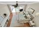 Aerial view of a bedroom with a ceiling fan, balcony access, and modern furnishings at 12274 1St W St # 2, Treasure Island, FL 33706
