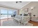 Bright bedroom featuring a large sliding door with beach views, hardwood floors, and stylish decor at 12274 1St W St # 2, Treasure Island, FL 33706