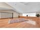 Bonus room with a wood floor, natural light, decorative area rug, and banister at 12274 1St W St # 2, Treasure Island, FL 33706