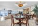 Elegant dining area featuring a round table, chandelier, and adjacent seating area at 12274 1St W St # 2, Treasure Island, FL 33706