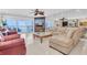 Spacious living room with a large sectional sofa, beach view, and mirrored wall at 12274 1St W St # 2, Treasure Island, FL 33706
