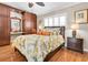 Comfortable main bedroom with a tropical leaf motif on the bedspread, and dark wood floors and furnishings at 12274 1St W St # 2, Treasure Island, FL 33706