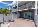 Exterior rear patio featuring brick flooring, a white fence, and beach views at 12274 1St W St # 2, Treasure Island, FL 33706