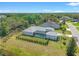 Aerial shot of home, pool, fenced yard, and mature trees near a pond at 12546 Wildebeest Way, Spring Hill, FL 34610