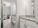 Bathroom view showing granite countertops, white cabinets and view into bedroom at 12546 Wildebeest Way, Spring Hill, FL 34610