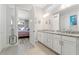 Bathroom with double vanity, granite countertops, and a view to the bedroom at 12546 Wildebeest Way, Spring Hill, FL 34610