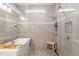 Modern bathroom featuring a soaking tub, glass enclosed shower, and pebble tile flooring at 12546 Wildebeest Way, Spring Hill, FL 34610