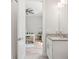 Bathroom with granite countertop, white cabinets, and a view into the study at 12546 Wildebeest Way, Spring Hill, FL 34610