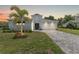 Beautiful single-story home with a manicured lawn, mature landscaping, and a brick paved driveway at 12546 Wildebeest Way, Spring Hill, FL 34610