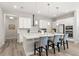 Kitchen with a large island, white cabinets, stainless steel appliances, and seating at the island at 12546 Wildebeest Way, Spring Hill, FL 34610