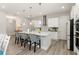 Kitchen island featuring barstool seating and quartz countertops, open to additional living spaces at 12546 Wildebeest Way, Spring Hill, FL 34610
