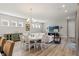 Open-concept living and dining area featuring wood floors and contemporary furnishings at 12546 Wildebeest Way, Spring Hill, FL 34610