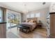 Primary bedroom with backyard views and decorative lighting, overlooking the pool area at 12546 Wildebeest Way, Spring Hill, FL 34610