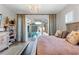 Bright bedroom with a view of the private pool area and neutral decor at 12546 Wildebeest Way, Spring Hill, FL 34610