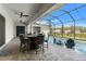 Enclosed patio includes outdoor dining with ceiling fans and view of pool at 12546 Wildebeest Way, Spring Hill, FL 34610