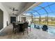 Enclosed patio includes outdoor dining with ceiling fans and view of pool at 12546 Wildebeest Way, Spring Hill, FL 34610