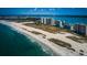 Stunning aerial view of the beach with high-rise buildings, showcasing beachfront living at 1270 Gulf Blvd # 501, Clearwater Beach, FL 33767