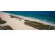 Aerial view showcasing a scenic beach with clear blue ocean and lush vegetation at 1270 Gulf Blvd # 501, Clearwater Beach, FL 33767