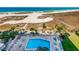 Community pool aerial view featuring lush landscaping and surrounding residential buildings at 1270 Gulf Blvd # 501, Clearwater Beach, FL 33767