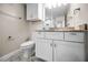 Bathroom featuring white vanity, decorative mirror, and modern fixtures at 1270 Gulf Blvd # 501, Clearwater Beach, FL 33767